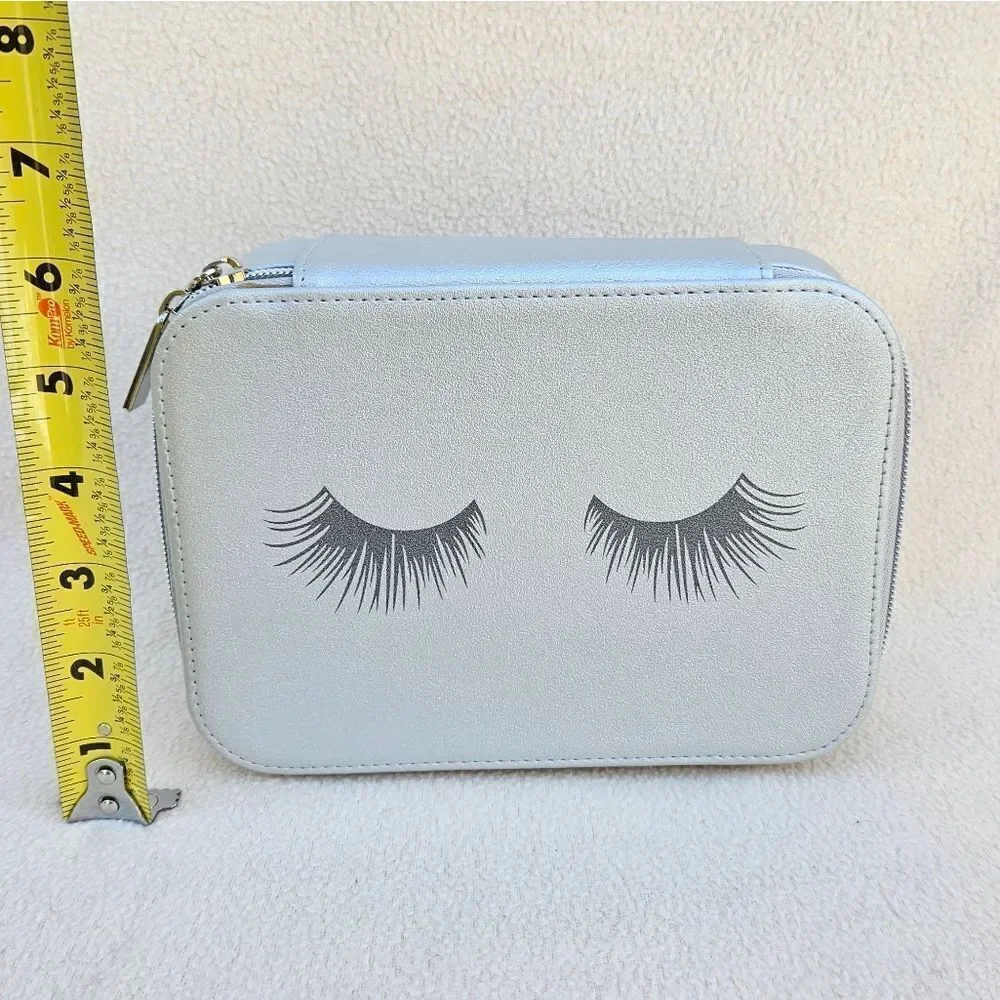 Neiman Marcus Silver Cosmetic Case with Eyelashes on the Front
